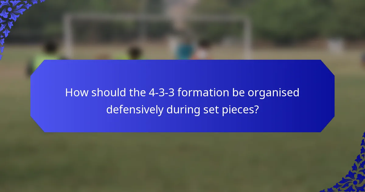 How should the 4-3-3 formation be organised defensively during set pieces?